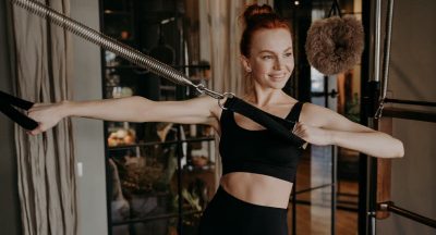 joyful-young-woman-pilates-instructor-doing-hand-s-2022-02-09-20-17-08-utc